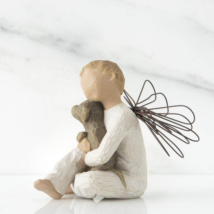 Statue of a child holding a dog with wings on a white background