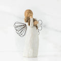 Angel figurine holding a child on a white background
