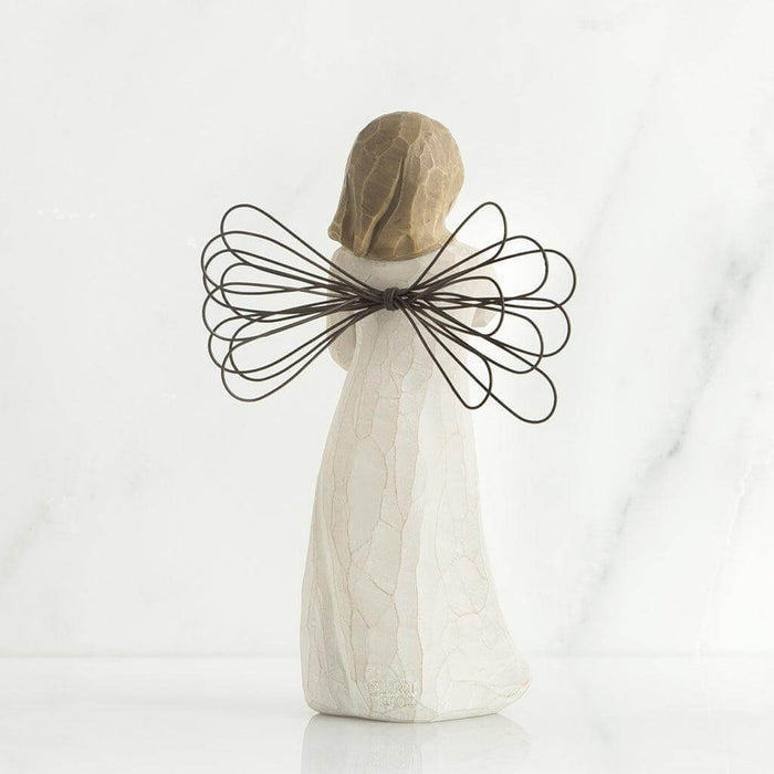 Decorative angel figurine with wire wings on a white background