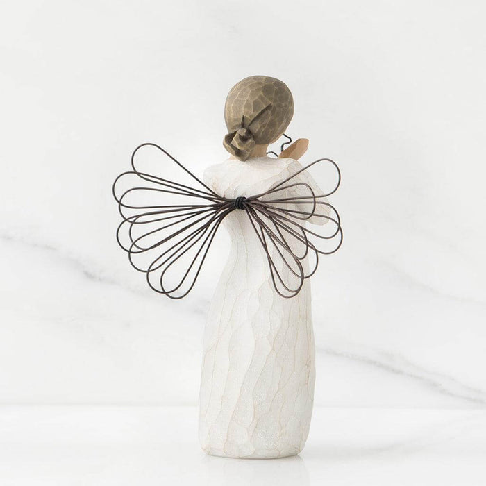 Decorative angel figurine with wire wings on a white background