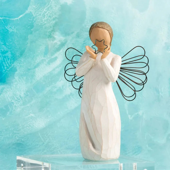 Angel Figurine holding a star on a blue background