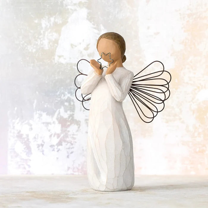 Angel Figurine holding a star on a multi color background