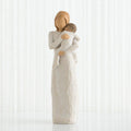 Statue of a mother embracing a child against a white background
