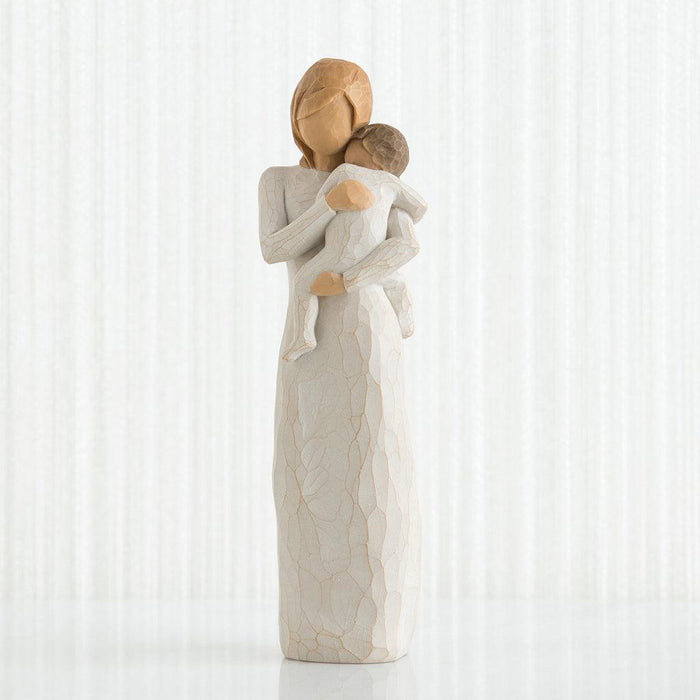 Statue of a mother embracing a child against a white background