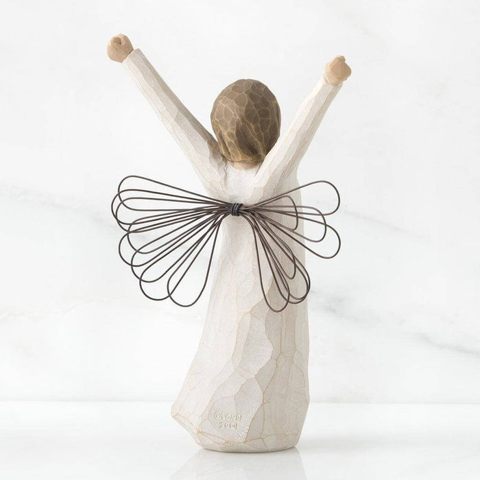 Decorative figurine of a person with outstretched arms and wire wings on a white background