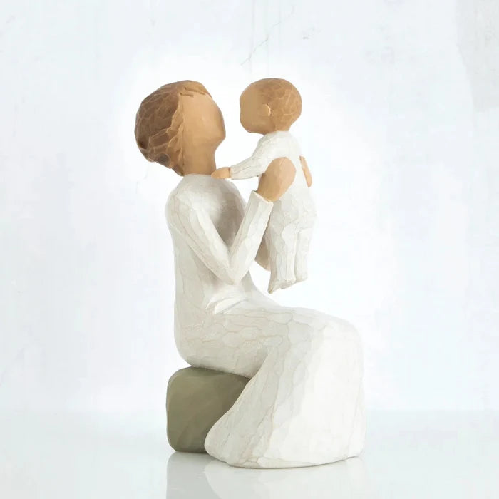 Willow Tree Grandmother figurine holding a baby on a white background