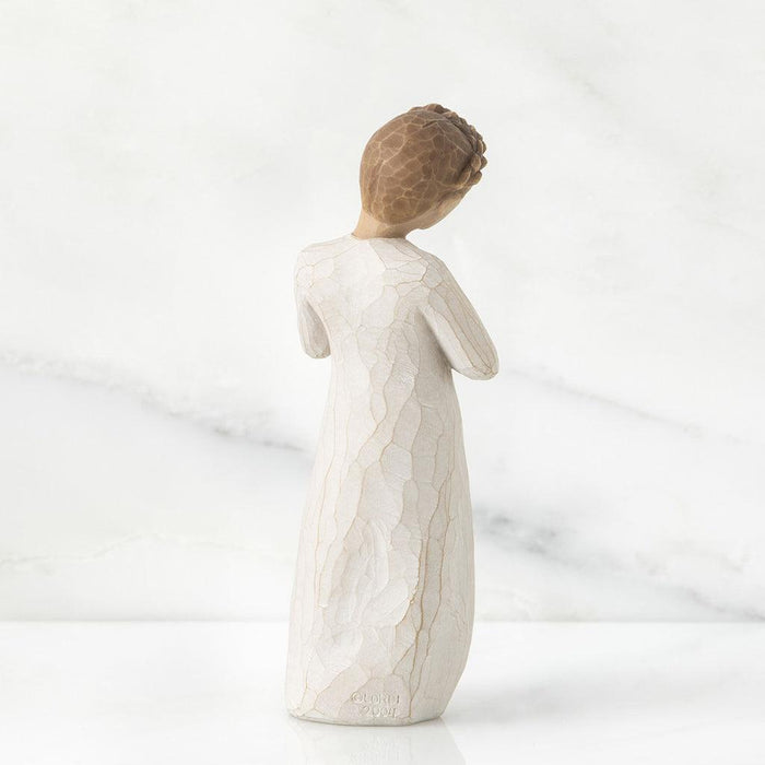 Statue of a woman in a flowing dress on a white background