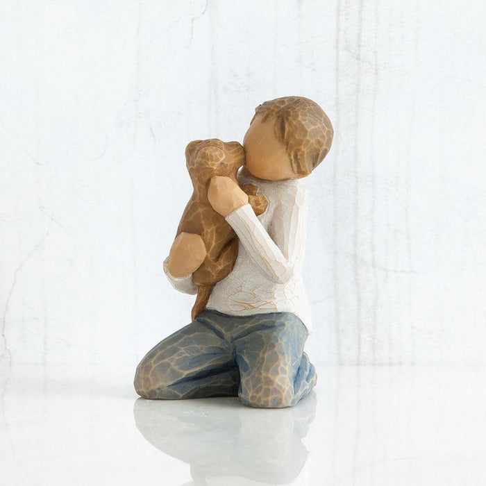 Figurine of a child hugging a teddy bear on a white background