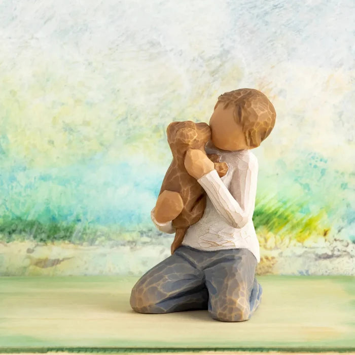 Wooden figurine of a person hugging a teddy bear against a colorful, abstract background