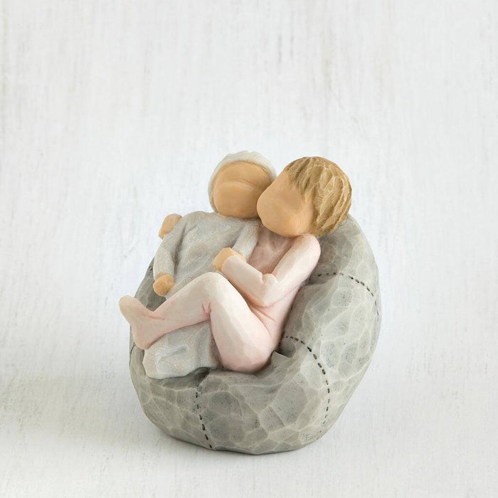 Small figurine of a children embracing on a textured surface