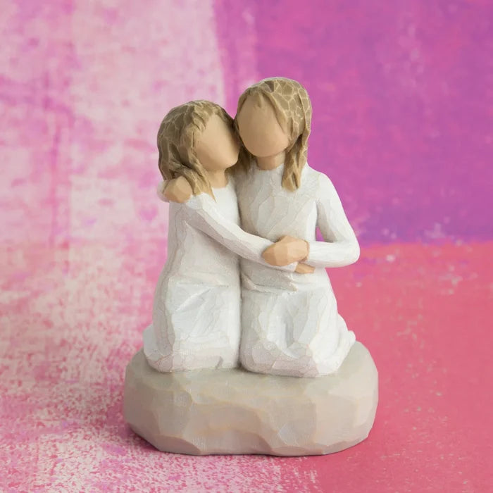 Willow Tree Sister Mine figurine showing two sisters sitting together
pink chock background