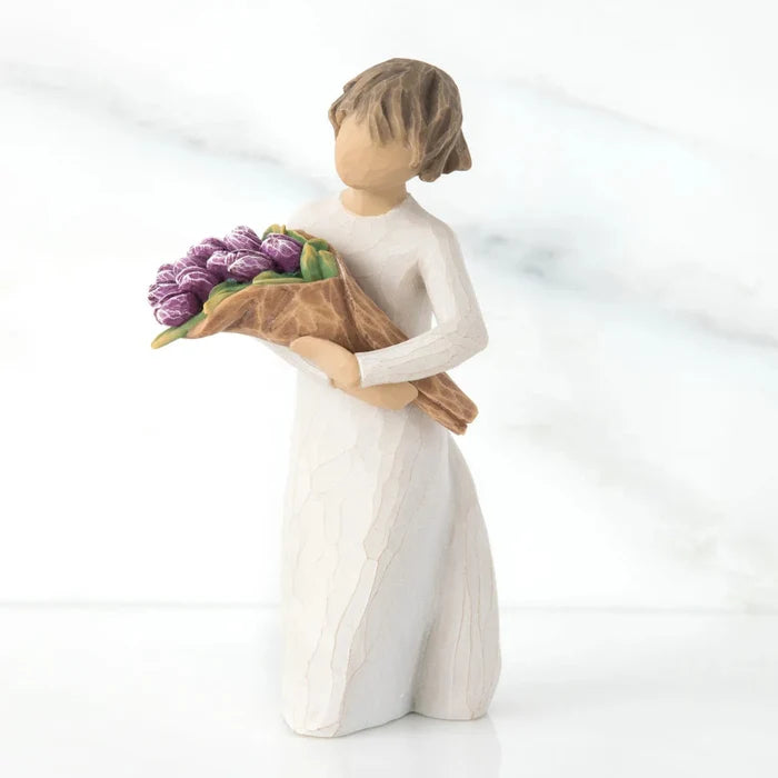 Hand-painted Willow Tree Surprise sculpture with purple bouquet on a white background
