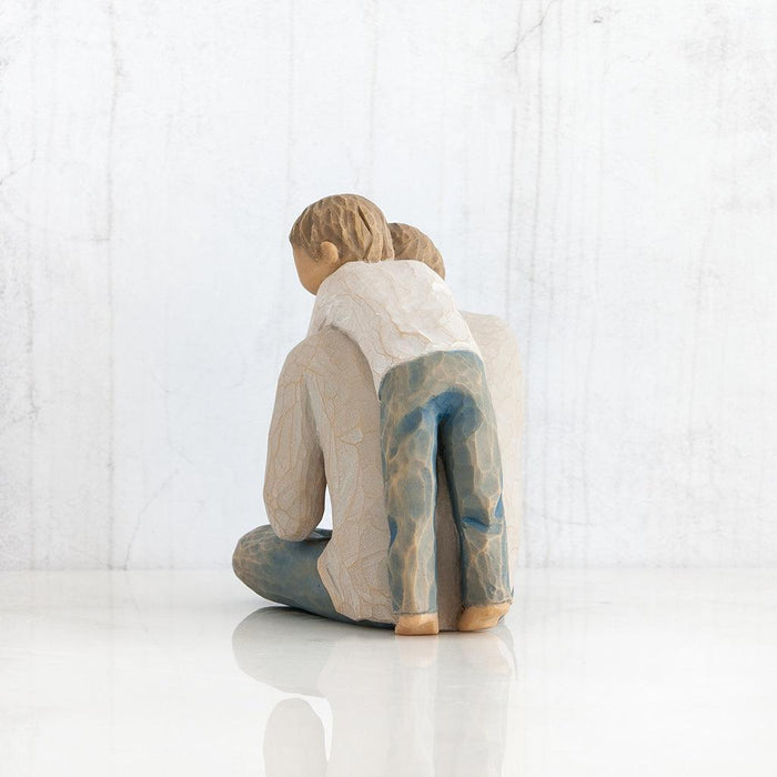 sculpture of a person sitting and a child on dads back  on a white background