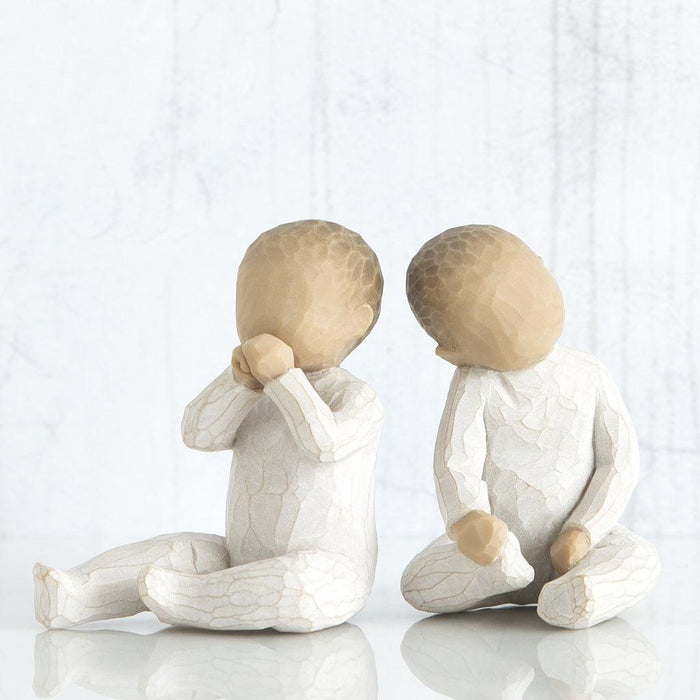 Two sitting figures with cracked textures on a white background