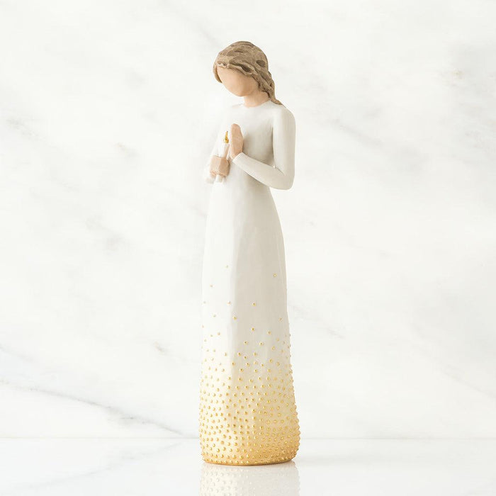 White figurine with a candle  with a gold base on a white background