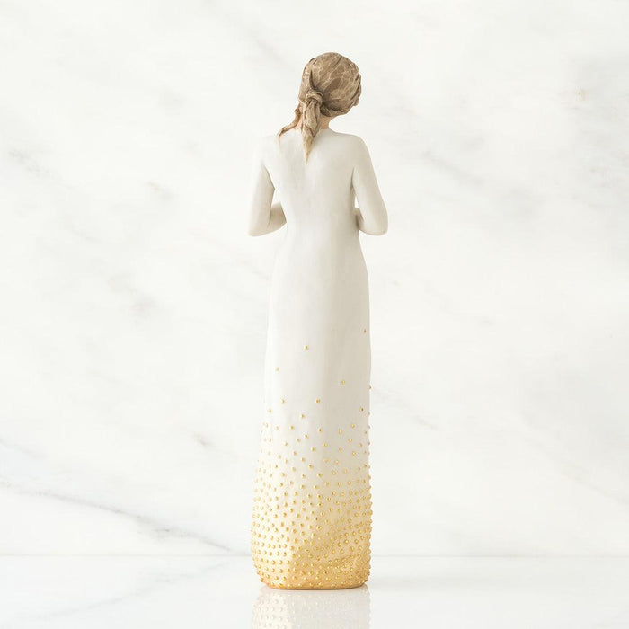 Decorative backside of a figure with a gradient design from white to gold on a white background