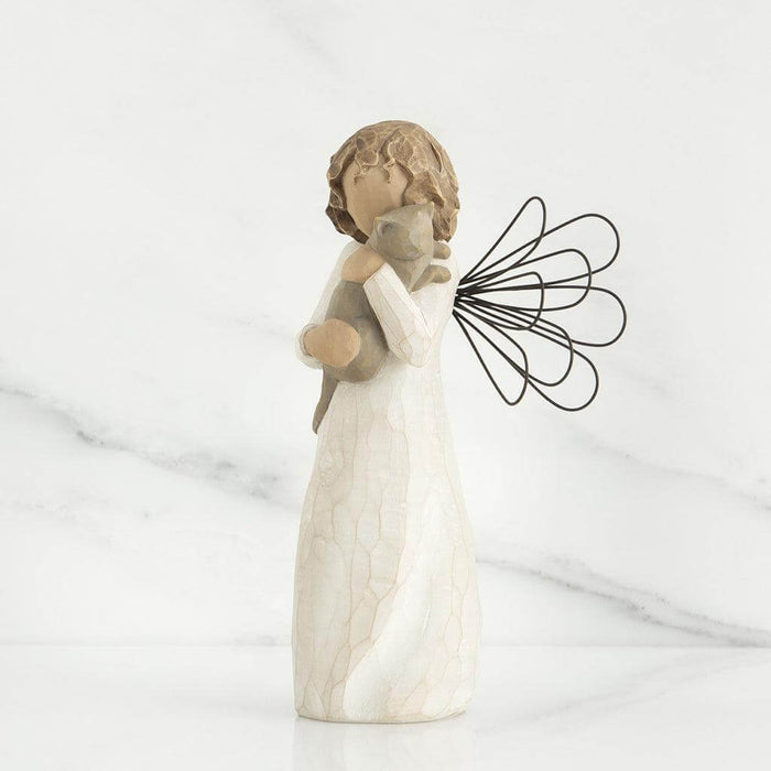 A white angel figuring holding a cat on a white background
