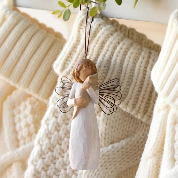 Wooden angel ornament hanging on a knitted blanket
