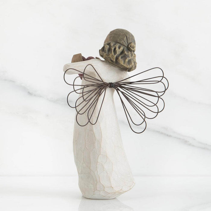 angel figurine with wire wings on a white background