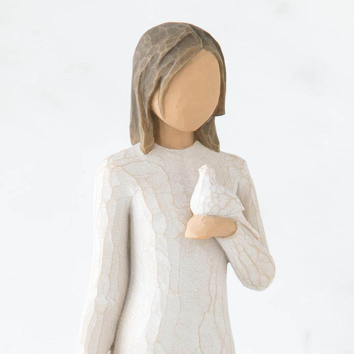 Statue of a woman holding a dove against a white background