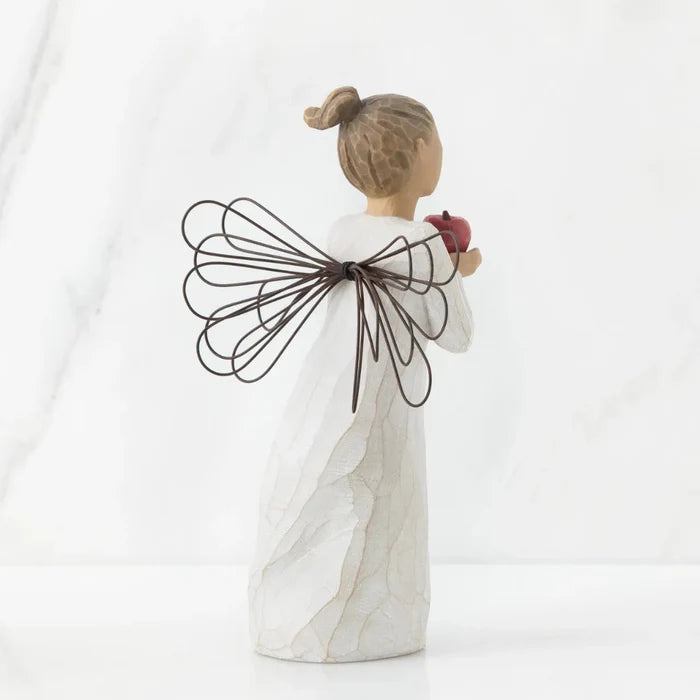 Decorative angel figurine with wire wings on a white background